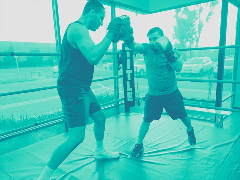 two men sparring inside boxing ring